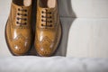 Closeup of Tanned Brogue Derby Shoes Made of Calf Leather with Rubber Sole Royalty Free Stock Photo