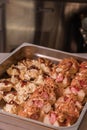 Closeup of tapas and pinchos with red peppers, sausages, crunchy onion, salad, mayonnaise, and bread Royalty Free Stock Photo