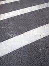 Closeup of a tar or asphalt pavement texture with white lines painted on asphalt road Royalty Free Stock Photo