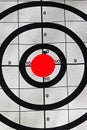 Closeup of a target bullseye with a bullet hole