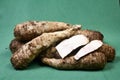 closeup of taro root vegetable, eddo malanga, green background Royalty Free Stock Photo