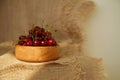 Closeup of tasty cherries in wooden bowl. Rustic style dessert