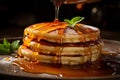 closeup tasty desert of a delicious stack of pancakes topped with sweet golden honey with mint leaves