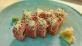 Closeup of tasty red tuna sushi rolls set decorated with spouts served on a plate with wasabi and ginger Royalty Free Stock Photo