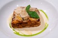 Closeup tasty traditional beef lasagne with cheese and basil leaves
