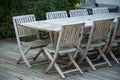 Teak garden furniture on a wooden terrace in spring