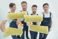 Closeup.a team of builders with paint rollers.i Royalty Free Stock Photo