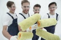 Closeup.a team of builders with paint rollers.i Royalty Free Stock Photo