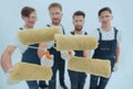 Closeup.a team of builders with paint rollers.i Royalty Free Stock Photo