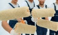 closeup.a team of builders with paint rollers.i Royalty Free Stock Photo