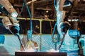 Closeup team industrial robots is welding assembly steel part in car factory Royalty Free Stock Photo