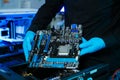 Closeup of technician installing motherboard inside computer case in modern lab, symbolizing innovation, hardware repair Royalty Free Stock Photo