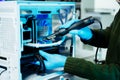 Closeup of technician repairing PC hardware using soldering tool in high-tech lab, representing technology maintenance, innovation Royalty Free Stock Photo