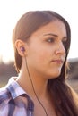 Closeup of teen listening to music on earphones