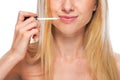 Closeup on teenage girl applying lip gloss Royalty Free Stock Photo