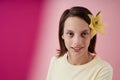 Closeup teenage girl with cerebral palsy smiling at camera on pink