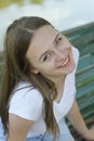 Closeup of teenage girl sitting, relaxing in the park, on a bench. Education, school girl. Smiling young woman. Summer time, Royalty Free Stock Photo