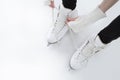 Closeup of Teenager Girl hands Lacing Up Iceskates