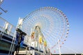 Giant Ferris Wheel on bright blue sky background
