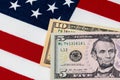 Closeup of ten and five dollar bills with American flag. Royalty Free Stock Photo