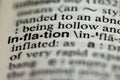 closeup of term and definition of inflation printed in dictionary on white page. Royalty Free Stock Photo