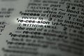 closeup of term and definition of recession printed and highlighted in dictionary on white page.
