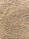 Close up on a texture of gravels in a Japanese zen dry garden depicting waves patterns. Royalty Free Stock Photo