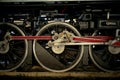 Closeup texture and background of steel locomotive wheel of vintage steam train atopping at the train station Royalty Free Stock Photo