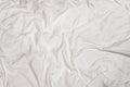 Closeup texture of crumpled white bed sheet with messy abstract pattern