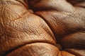 A closeup of the texture on light brown leather, showcasing its soft and delicate surface with subtle unique patterns and tex Royalty Free Stock Photo