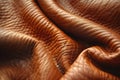 A closeup of the texture on light brown leather, showcasing its soft and delicate surface with subtle unique patterns and tex Royalty Free Stock Photo