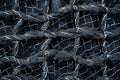 A closeup of the texture and pattern on black mesh fabric, with white metal wire threads that form an intricate grid against a so