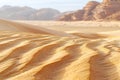 A closeup of the texture and pattern in sand ripples, with a beige color tone. the background is a vast expanse of light brow