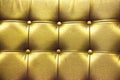 Closeup texture of vintage gold leather sofa for background Royalty Free Stock Photo