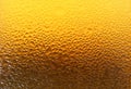 Closeup Texture of Water Droplets on Gradient Golden Yellow Lager Beer Glass Bottle Royalty Free Stock Photo