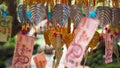Closeup of Thai baht donation money and metallic leaf decoration