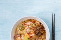 Closeup Thai style spicy egg noodle soup with wanton