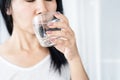 Closeup thirsty Asian woman drinking water glass