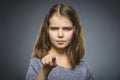 Closeup Thoughtful or contemptuous girl show at camera isolated on Gray