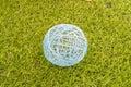 Closeup of a thread white ball on a green grass background Royalty Free Stock Photo