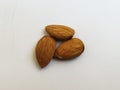 Closeup of three Almond Nuts isolated in a white background