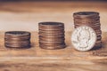 Closeup of three american quarters stacks with a coin on the face side standing against the highest pile. Free trade, economy,