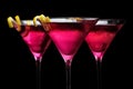 Closeup three cosmopolitan drinks isolated on black