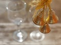 Closeup three golden Christmas bells hanging on the blurred back Royalty Free Stock Photo