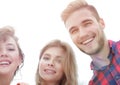 Closeup of three young people smiling on white background Royalty Free Stock Photo