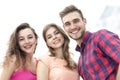 Closeup of three young people smiling on white background