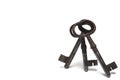 Closeup three old keys leaning white background Royalty Free Stock Photo