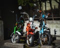 Closeup of three old mopeds parked at a street