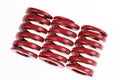 Closeup three red strong metal springs isolated on a white