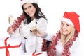 Closeup.three young women in hats of Santa Claus with Christmas gifts and glasses of champagne Royalty Free Stock Photo